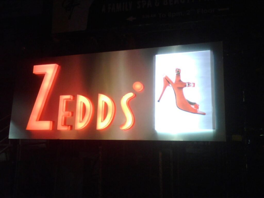 Backlit acrylic LED sign board with illuminated letters for retail branding in Hyderabad, Jubilee Hills.