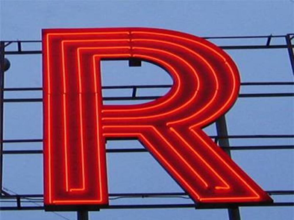 Custom red neon LED letter signage manufactured by Sina Interior & Signage in Hyderabad for retail stores, restaurants, cafés, and commercial branding.