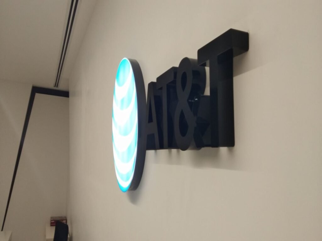 Backlit acrylic logo signage with LED illumination manufactured by Sina Interior & Signage in Hyderabad for premium corporate interiors.