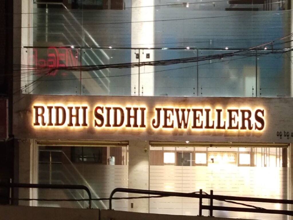 Warm LED sign board illuminated stainless steel channel letter signage for Ridhi Sidhi Jewellers by Sina Interior & Signage in Hyderabad for premium jewellery showroom branding.