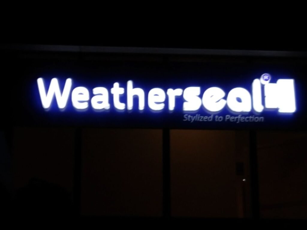 Illuminated LED sign board channel letter signage for Weatherseal designed and installed by Sina Interior & Signage in Hyderabad for commercial storefront branding.